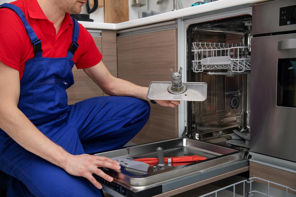 Dishwasher repair instead of replacement Handyman repairing a domestic dishwasher in a home kitchen, featuring Accurate Appliance Repair and highlighting professional dishwasher repair services, aligned with the page’s focus on reliable appliance solutions.